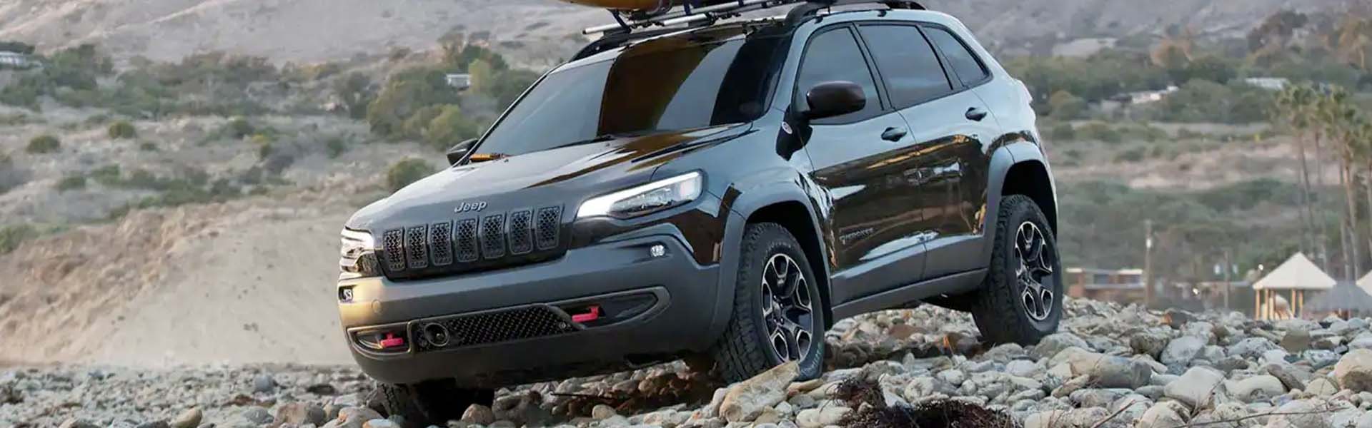 Red 2022 Jeep Cherokee parked on rocks