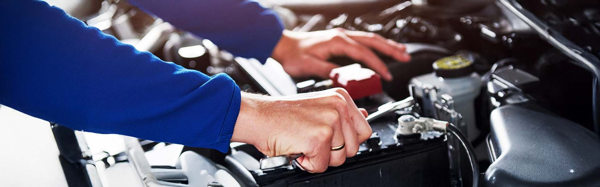 mechanic servicing a battery